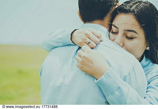 Concept of a couple lovingly embracing each other in the field  Close up of a girl giving a loving hug  close up of a girl giving a hug of love and comfort
