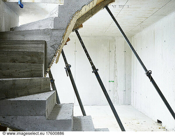 Concrete staircase supported by metal poles at construction site
