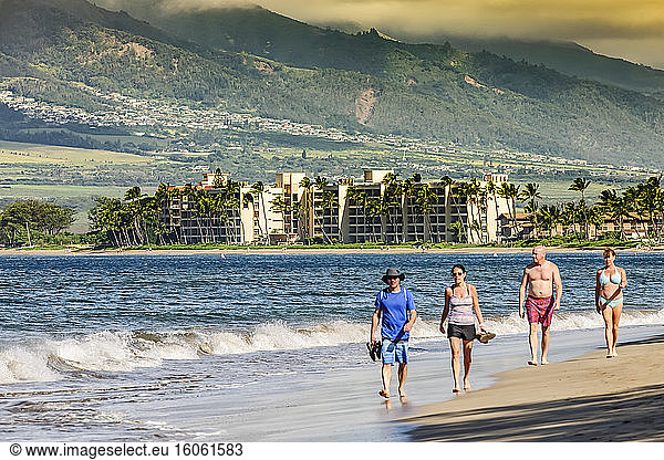 Condos on the beach and the West Maui mountains form a backdrop for beach strolling on South Maui; Maui  Hawaii  United States of America