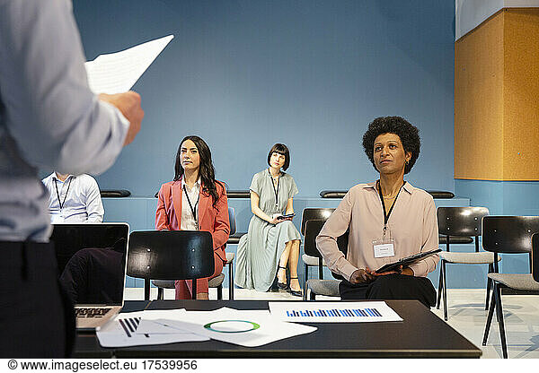 Conference members sitting at safe distance in board room