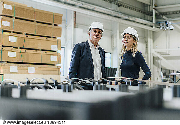 Confident business colleagues standing together in carpentry factory