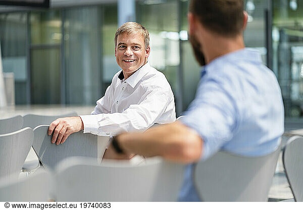 Confident businessman meeting colleague in company auditory