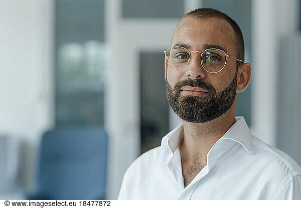Confident businessman wearing eyeglasses at home office