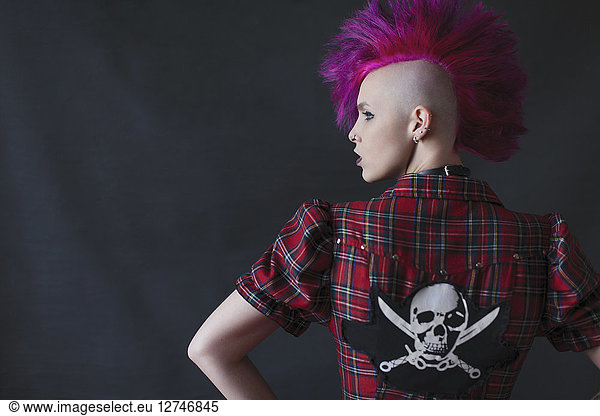 Confident  cool young woman with pink mohawk