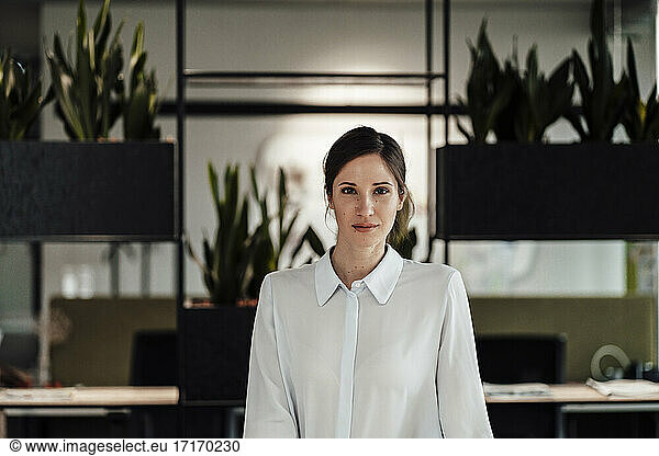 Confident female entrepreneur in office
