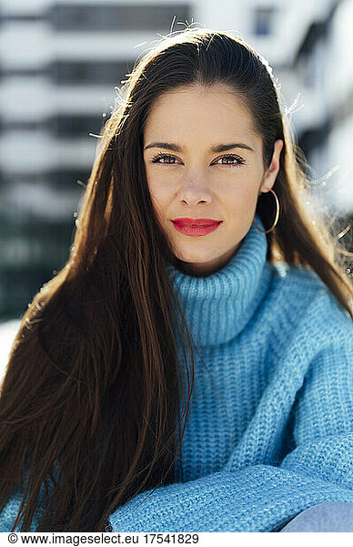 Confident woman wearing blue turtleneck sweater