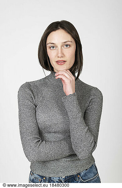 Confident woman wearing turtleneck over white background