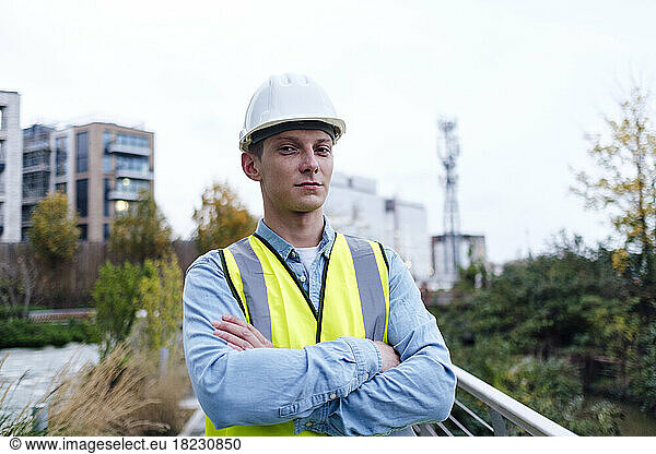 Confident young engineer with arms crossed