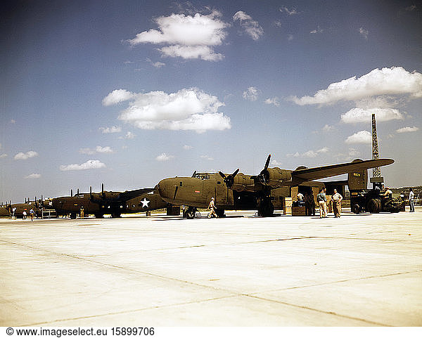Consolidated transport planes being loaded  Consolidated Aircraft Corp.  Fort Worth  Texas  USA  photograph by Howard R. Hollem  U.S. Office of War Information  October 1942