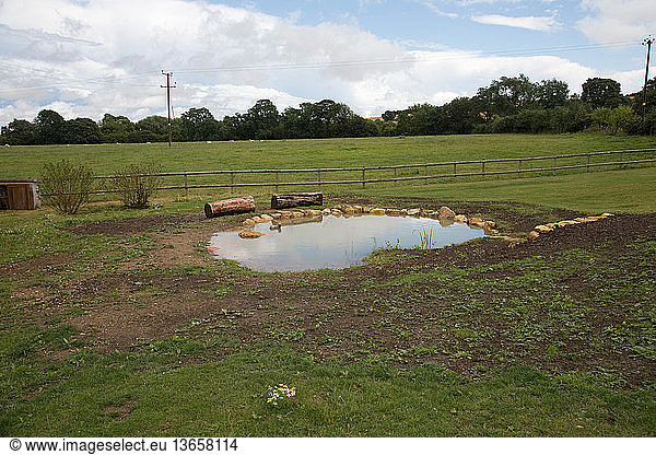 Constructing a wild pond at Colemans Hill Farm eco-house in Mickleton  UK.