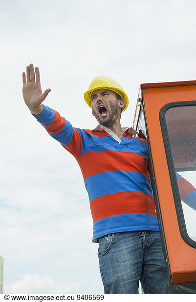 Construction worker on site with excavator