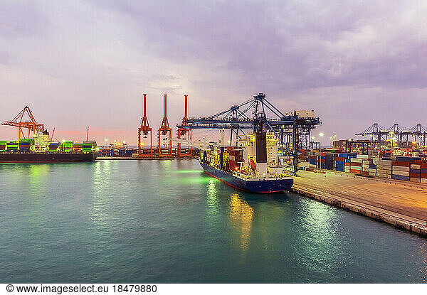 Container ships at illuminated dock