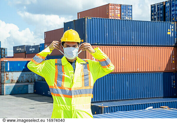 Container worker wearing protection face mask during coronavirus