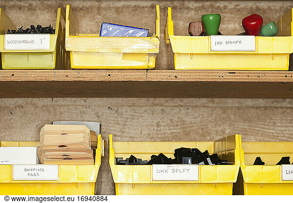 Containers with stationery on shelves.