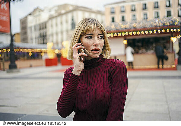 Contemplative woman talking on mobile phone