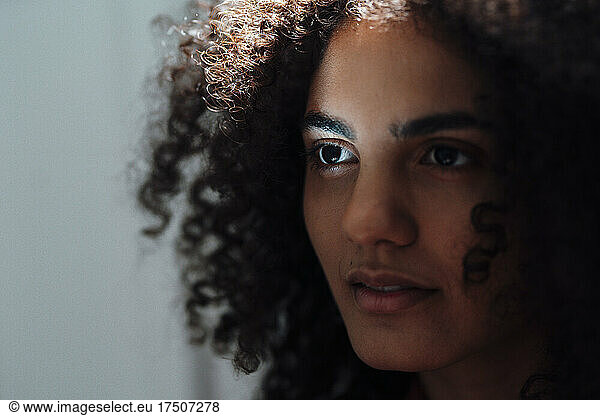 Contemplative woman with curly hair