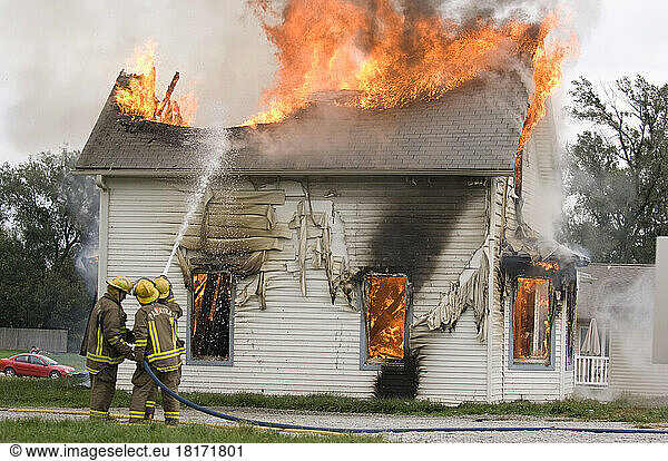 Controlled burn on a house in Palmyra  NE. Local fire fighters practiced their technique on the house; Palmyra  Nebraska  United States of America