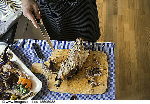 Cook carving a roasted duck