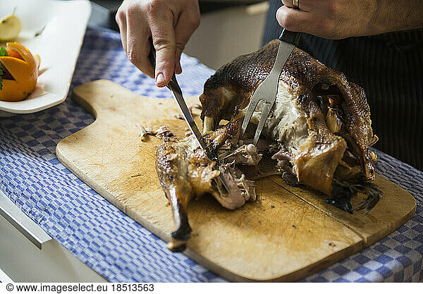 Cook carving a roasted duck