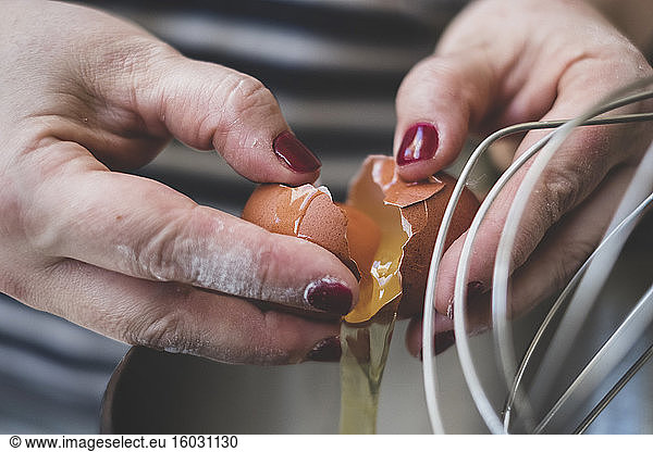 Cook separating eggs for baking.