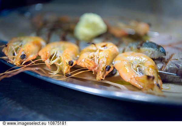 Cooked prawns on dish in traditional Italian restaurant kitchen  close up