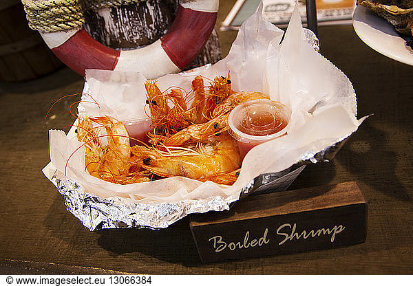 Cooked Shrimps in tissue paper on table