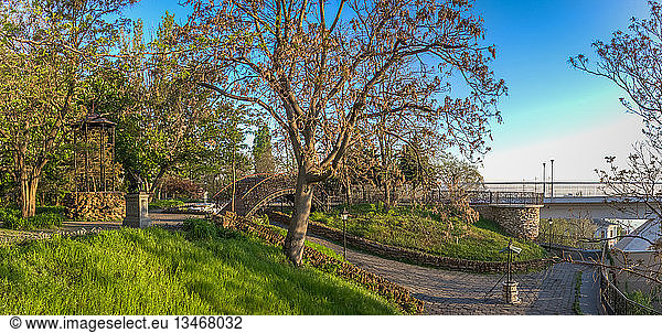 Corner of old Odessa near Mother in law bridge to Primorsky Boulevard in a spring morning. Panorama view.. Small square of old Odessa in Ukraine. Small square of old Odessa in Ukraine