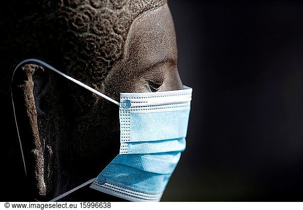 Coronavirus (COVID-19) epidemic. Buddha statue white medical face mask.