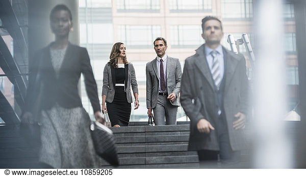 Corporate business people descending stairs