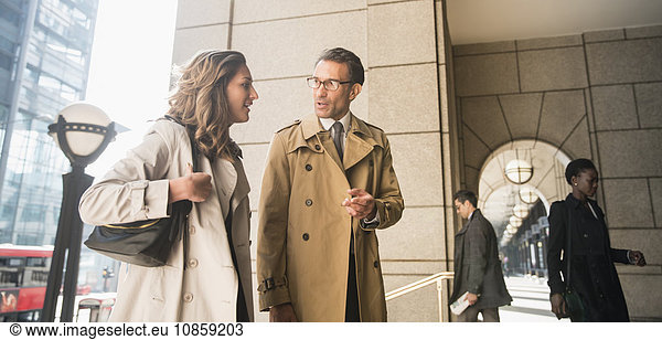 Corporate businessman and businesswoman talking outdoors