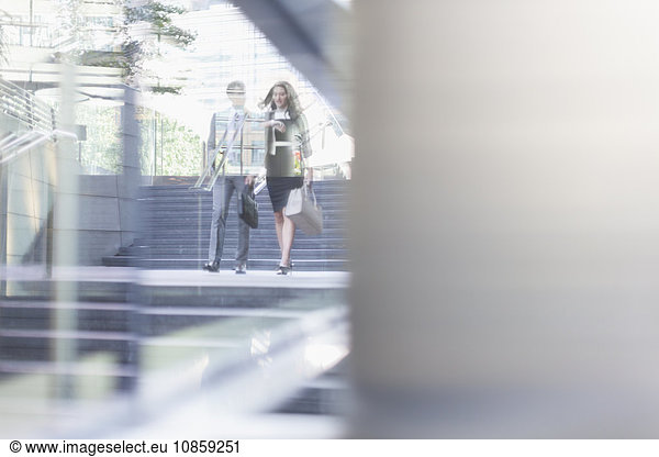 Corporate businessman and businesswoman walking outdoors