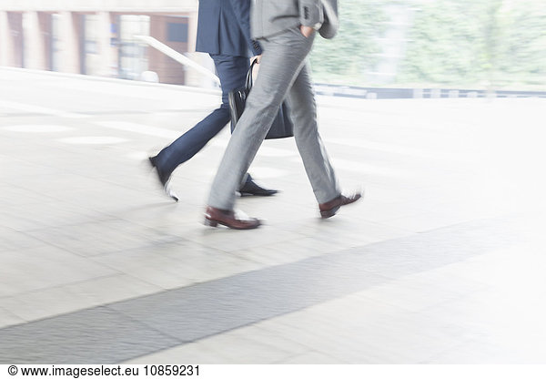 Corporate businessmen walking outdoors