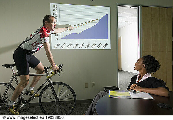Corporate executive gives power point presentation on success while training to race his bicycle  Santa Clara  California.