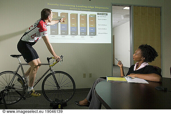 Corporate executive gives power point presentation on success while training to race his bicycle  Santa Clara  California.