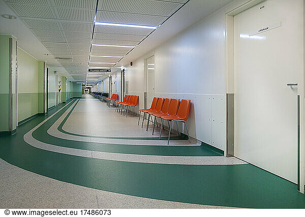 Corridor and waiting areas of a modern hospital with seating