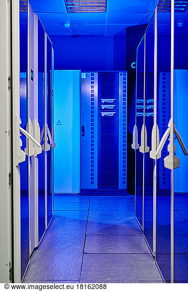 Corridor of illuminated server room with blue neon light
