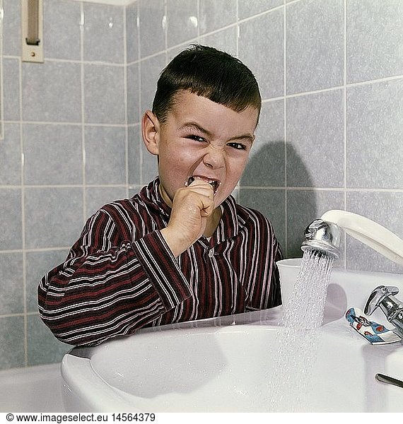 cosmetics  dental care  little boy during teeth brushing  1960s
