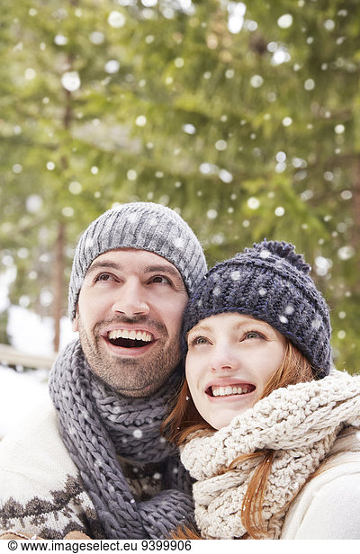 Couple admiring snow together