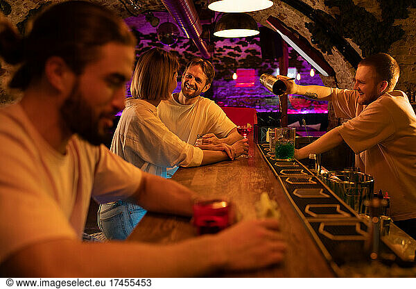 Couple and barman during party