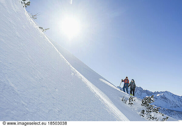 Couple climbing up the ski slope in Upper Bavaria  Germany  Europe