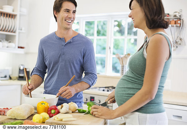 Couple cooking together in kitchen