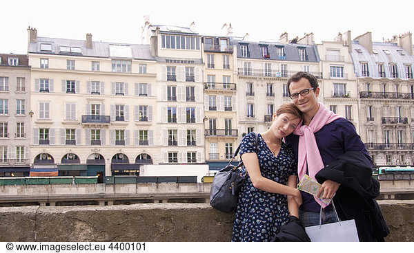 Couple embrace after shopping in Paris
