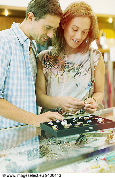 Couple examining jewelry together in store