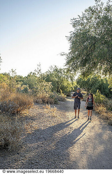 Couple hiking desert nature trail vertical