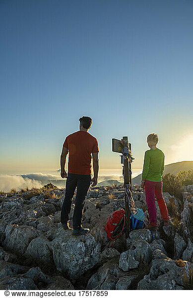 Couple hiking on Oltá mountain  Calpe  Alicante  Spain