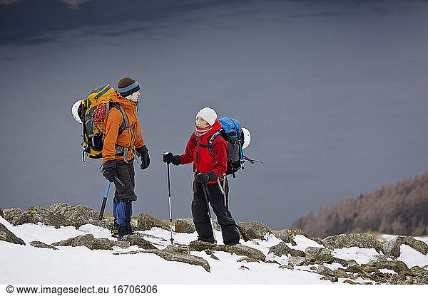 couple hiking up Helvellyn mountain in the Lake District