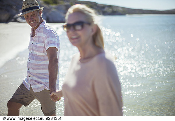 Couple holding hands on beach