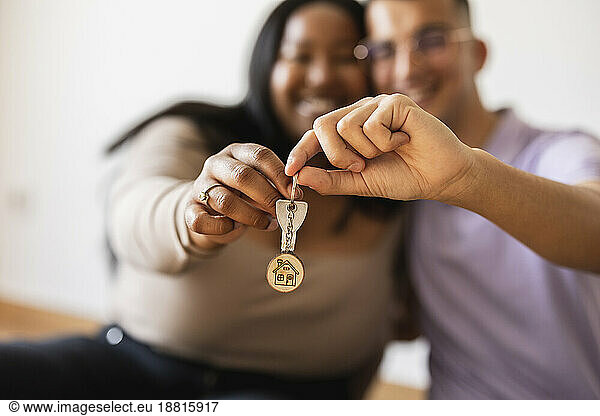 Couple holding house key in new home