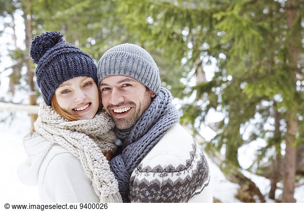 Couple hugging in snow