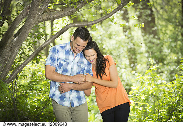 Couple hugging in the woods